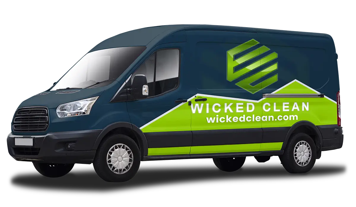 Side view of a dark blue delivery van with bright green geometric house graphic and text WICKED CLEAN and wickedclean.com